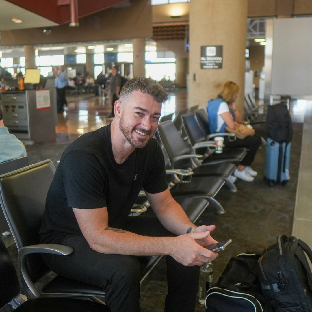Douglas at the airport on his way to a client