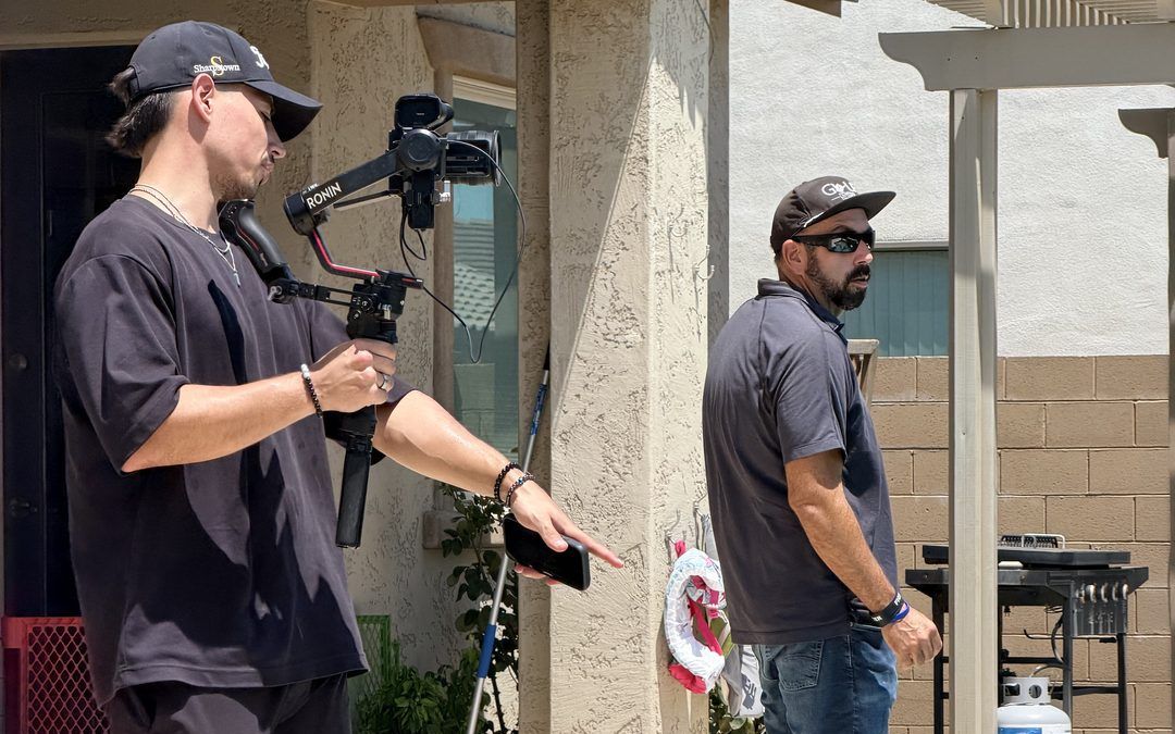Filming a contractor as he walks the stone deck of a pool job site