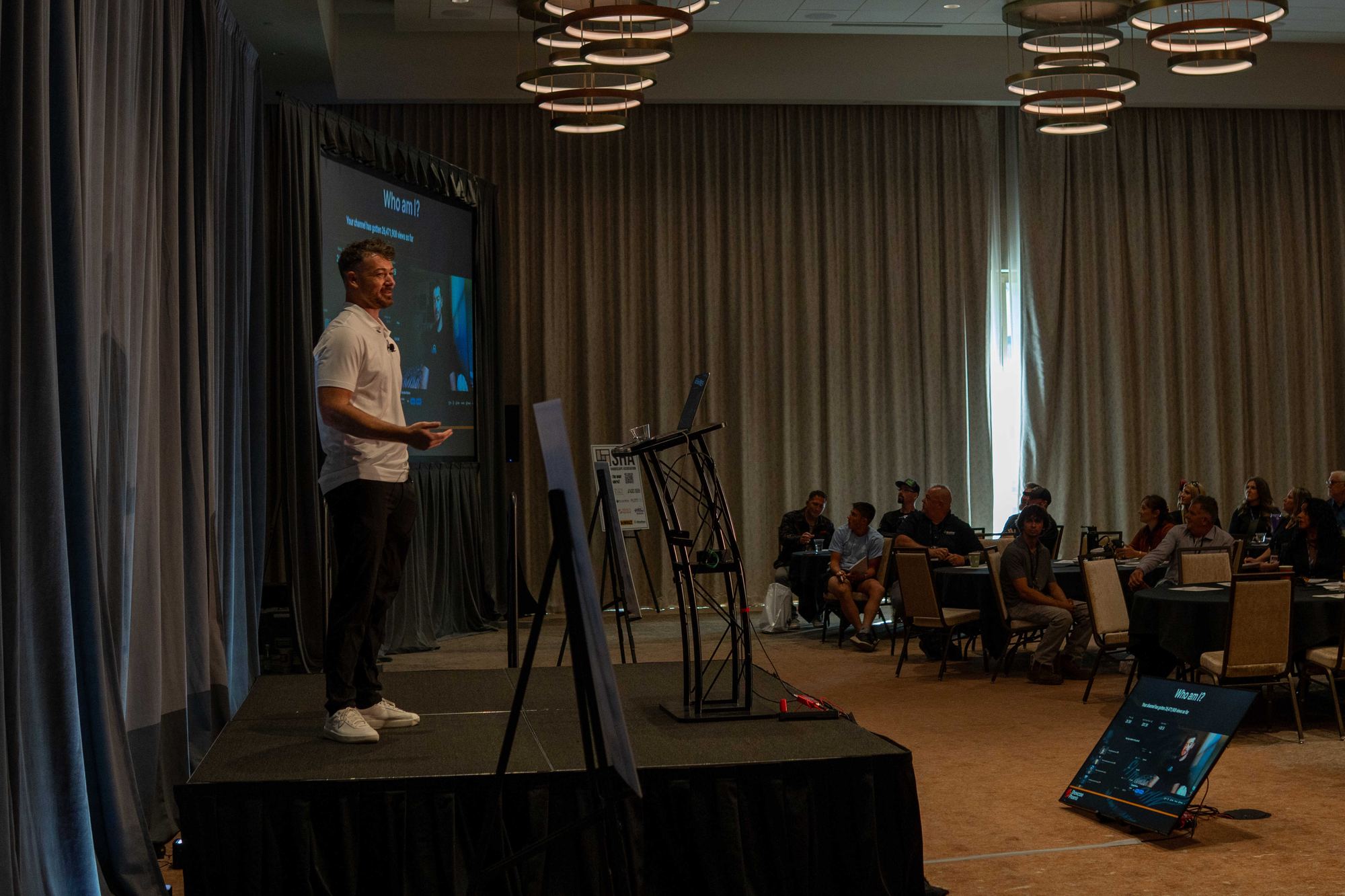 Douglas Laird speaking to a full room at an industry event
