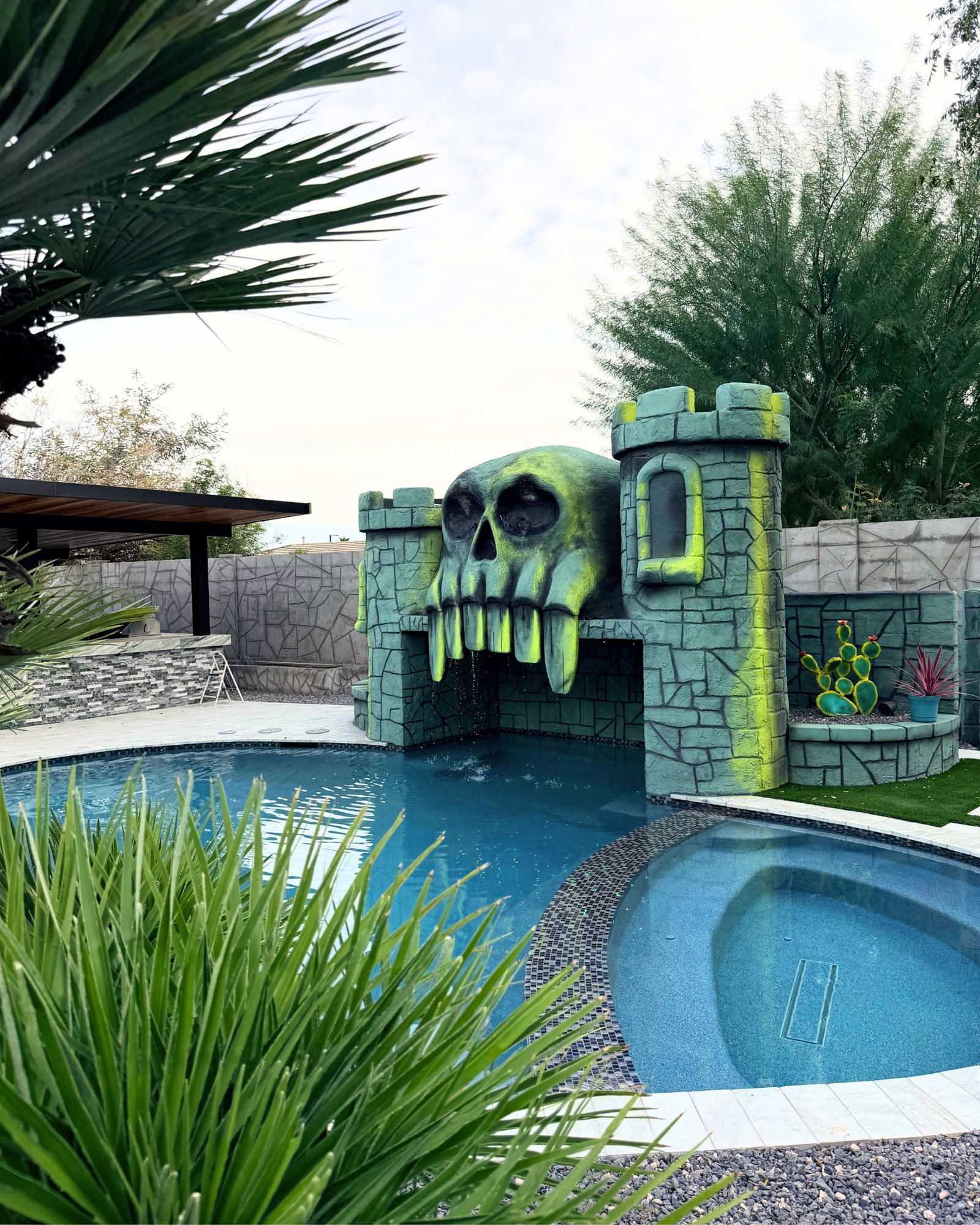 Finished custom pool with castle-and-skull grotto and waterfall in Surprise, AZ