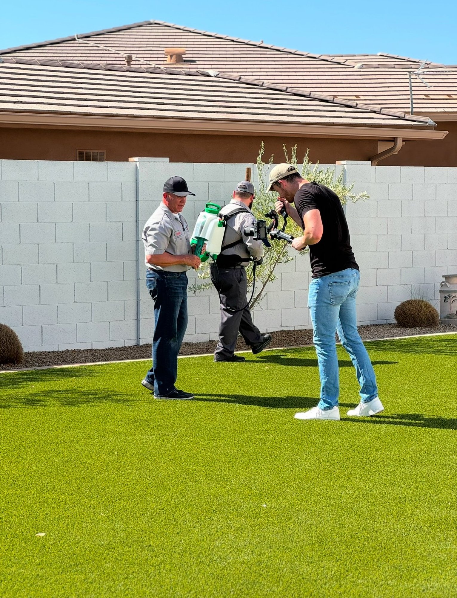 Douglas Laird filming in a client's backyard