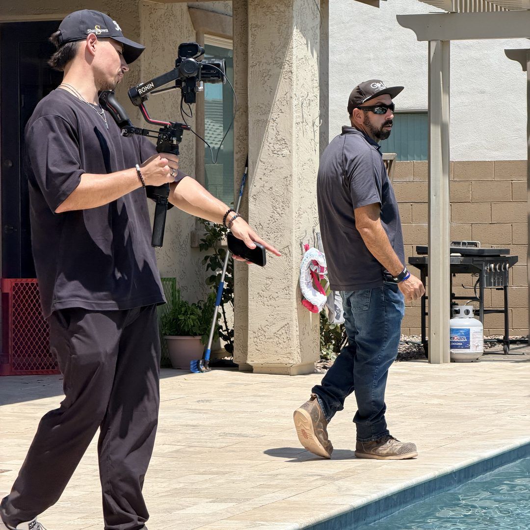 Our crew filming a contractor beside a finished pool