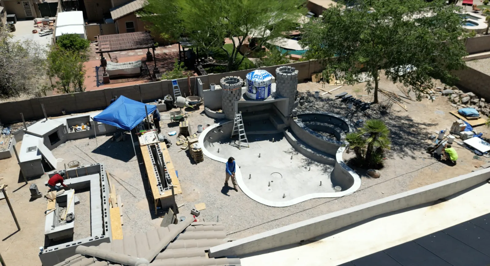 Aerial view of a custom pool and outdoor living project under construction